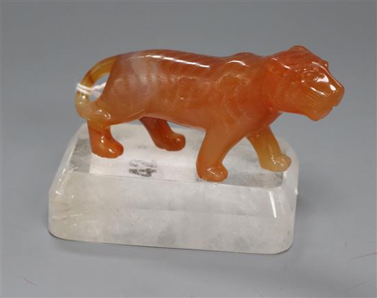 A Chinese chalcedony figure of a tiger with a rock crystal, on stand width 9.5cm